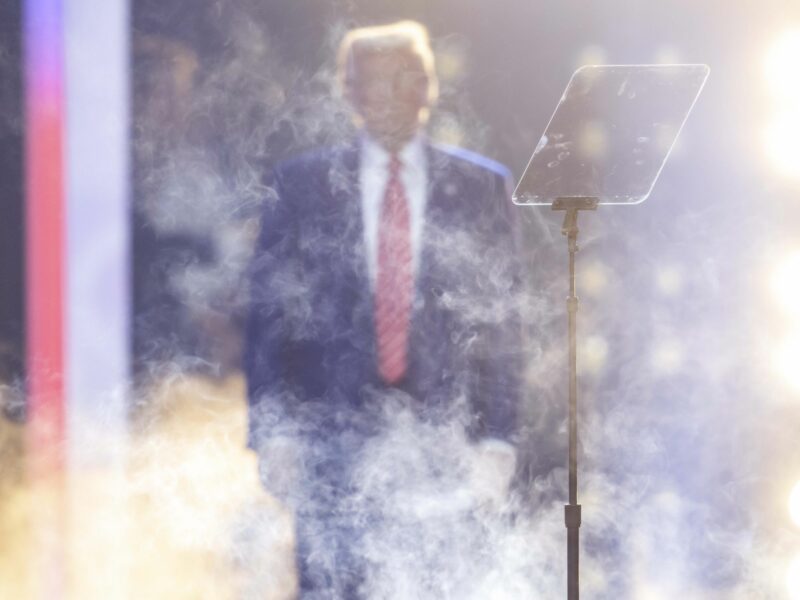Photo of Donald Trump taking the stage amid smoke effects in Phoenix, Arizona, on Dec. 22