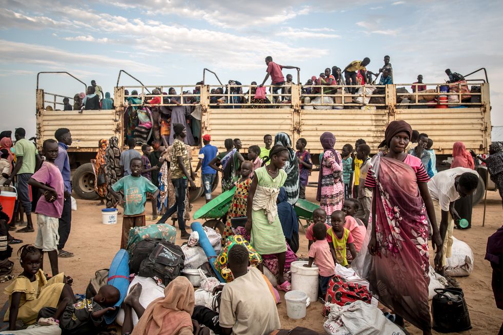 Photo of dozens of Sudanese war refugees disembarking a truck near the Joda border crossing in South Sudan.