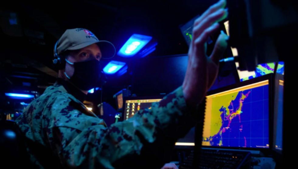 Photo of ​a soldier aboard a U.S. submarine, monitoring Russian exercises in the Kuril Islands