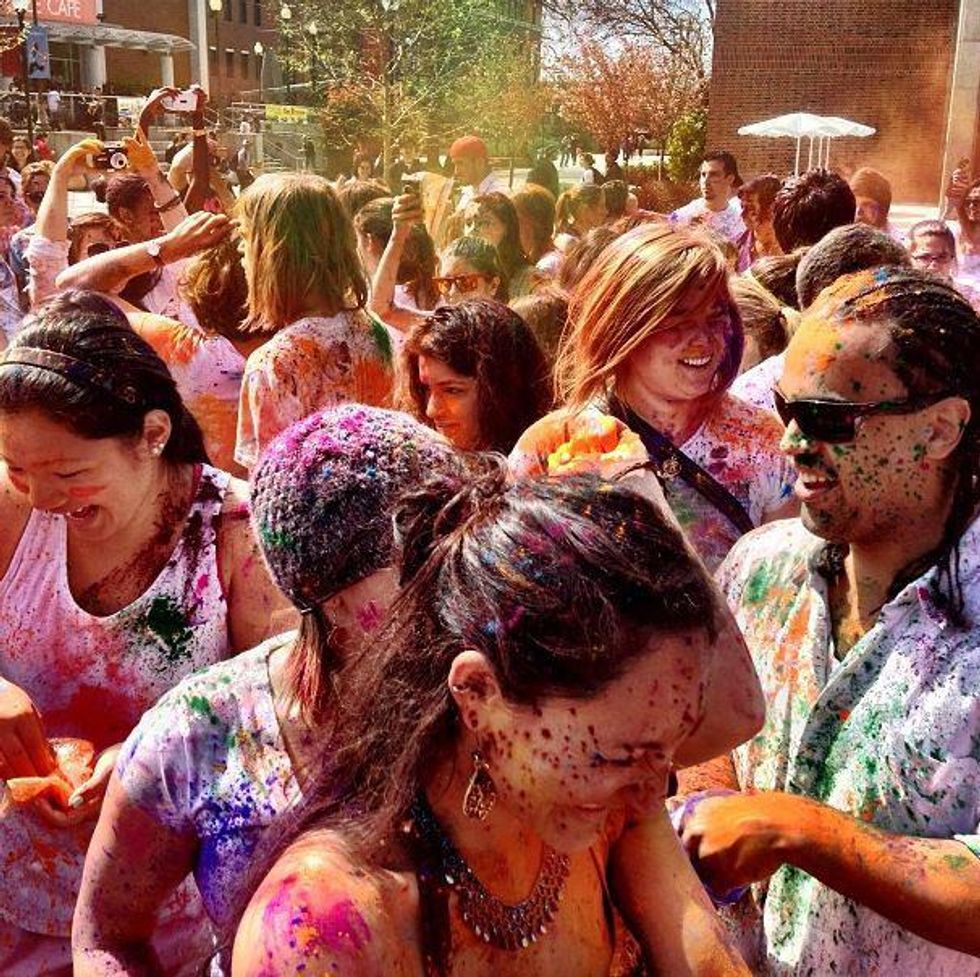 Photo of ​California State University students throwing colored powder to celebrate Holi
