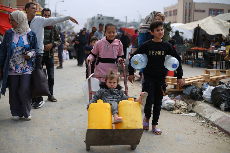 photo of ​Children getting water with a wheelbarrow