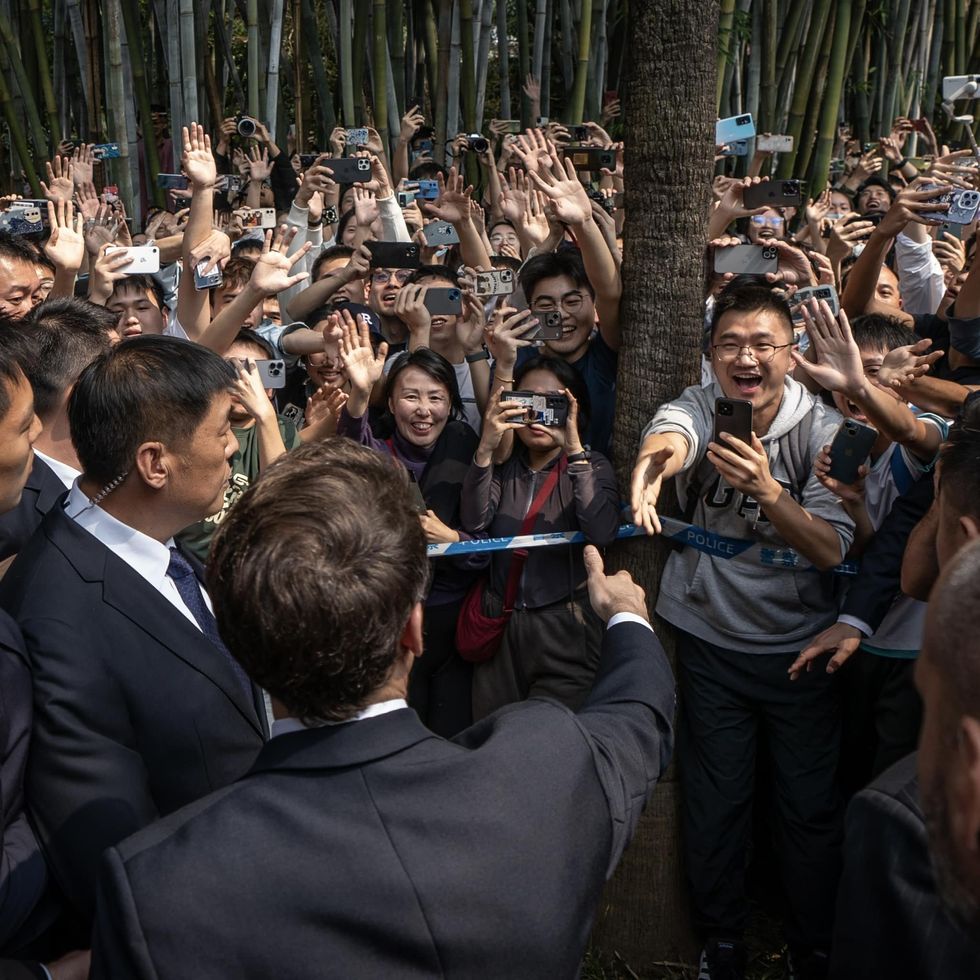 Photo of ​Emmanuel Macron greeting a crowd in China during his state visit