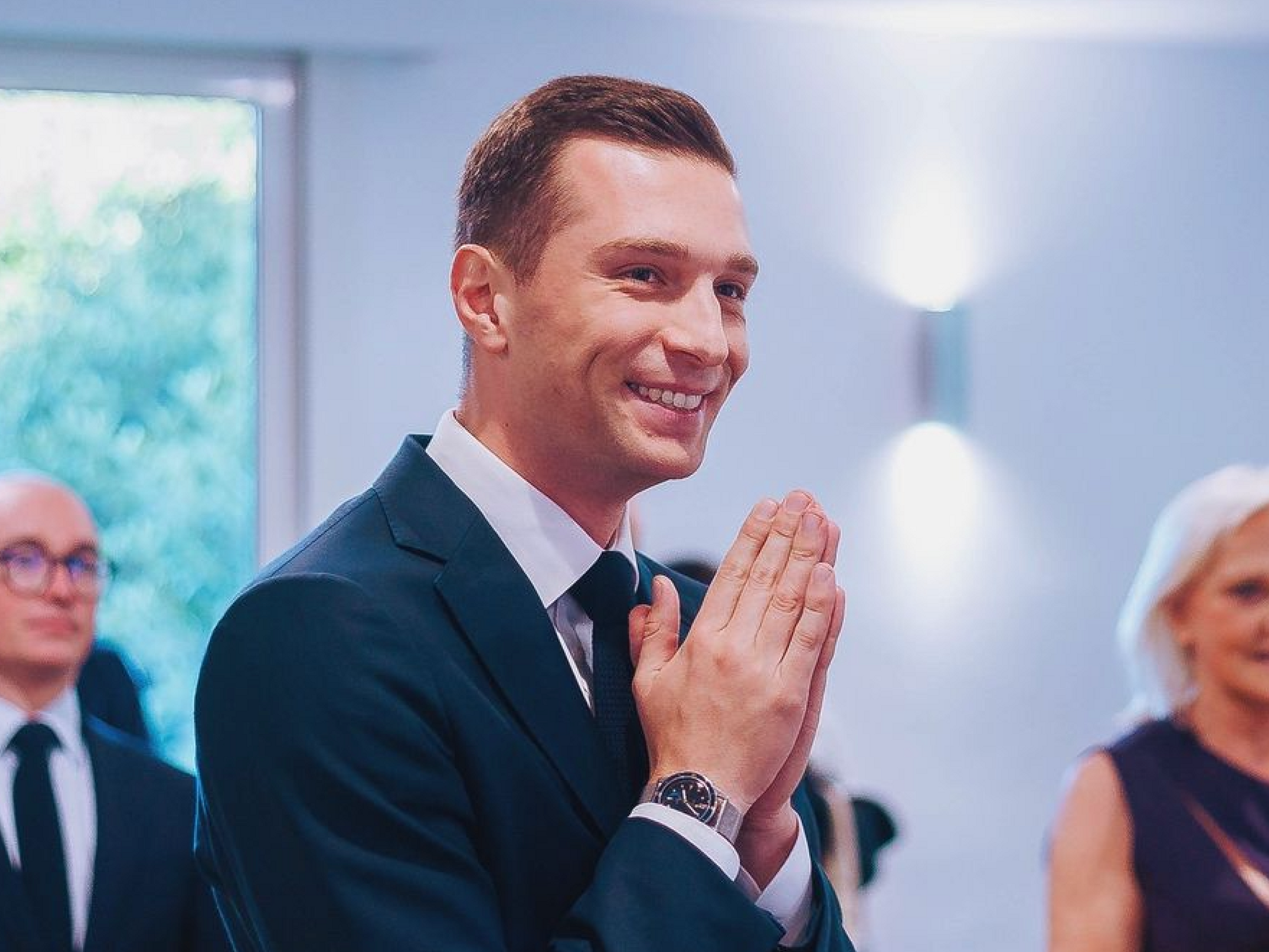 Photo of ​French far-right National Rally president Jordan Bardella joining hands in thanks