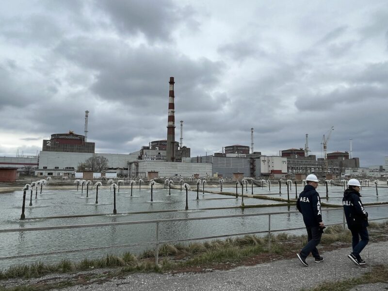 Photo of ​IAEA inspectors walking near the Zaporizhzhia power plant in March 2023