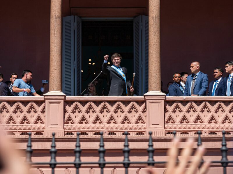 photo of ​Milei holding up his fist in front of supporters