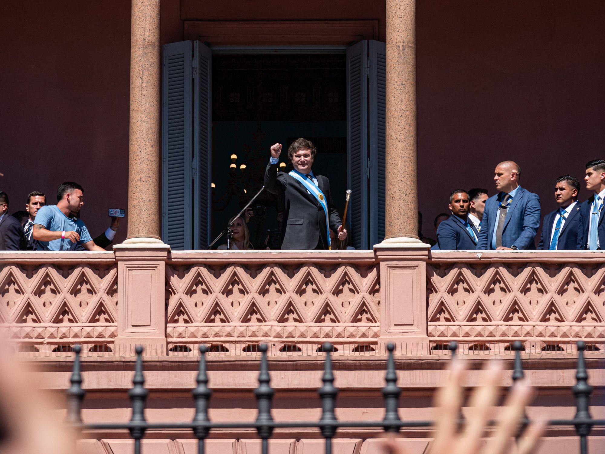 photo of ​Milei holding up his fist in front of supporters