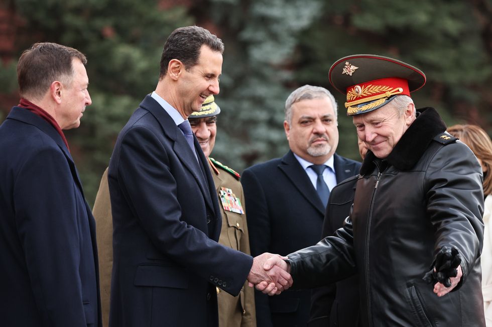 Photo of ​Syrian President Bashar al-Assad (2nd L) and military commandant of Moscow Yevgeny Selezenev (R) shaking hands during a wreath laying ceremony at the Tomb of the Unknown Soldier by the Kremlin Wall, Moscow, Russia, March 15, 2023.