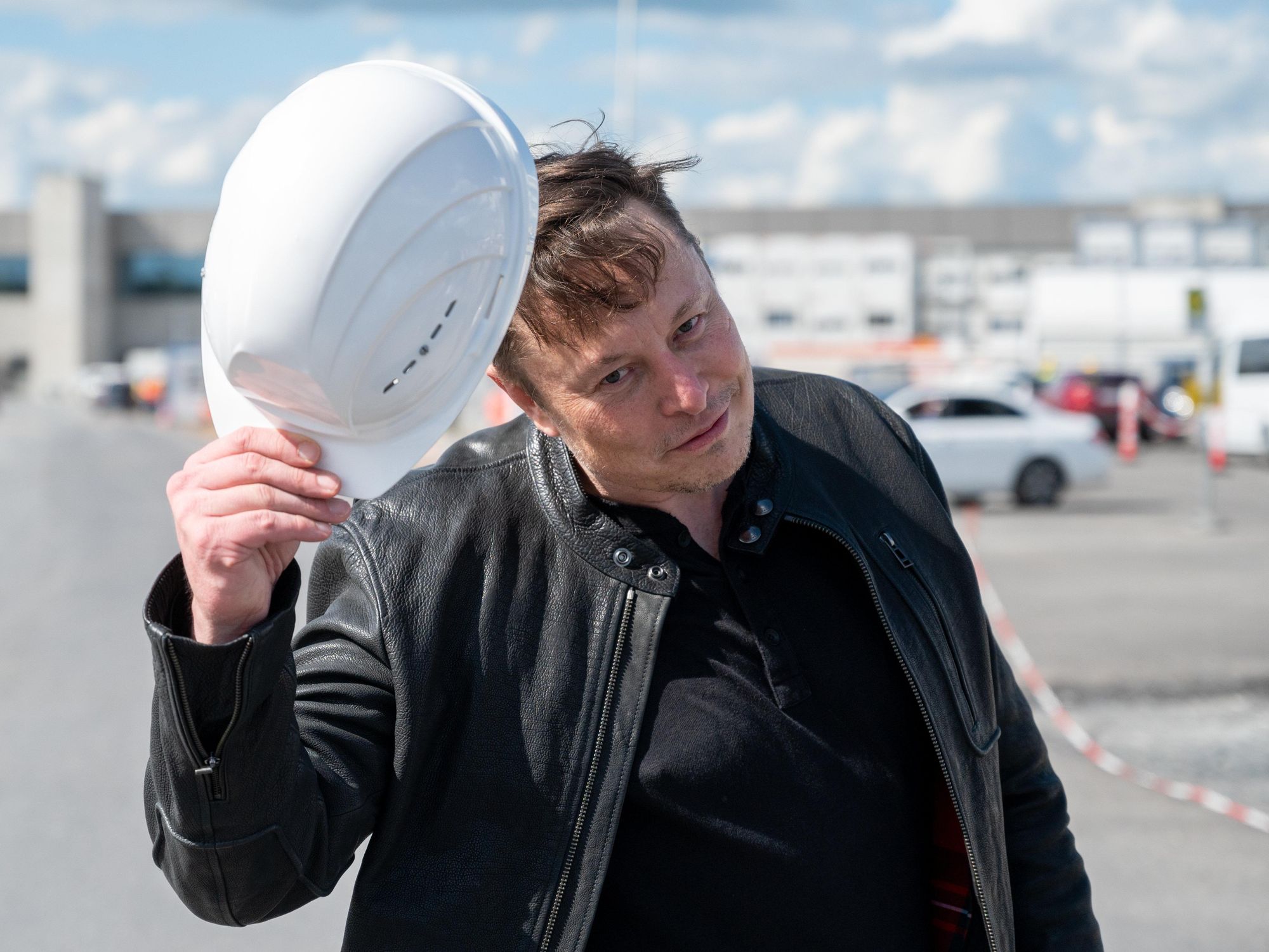 Photo of ​Twitter's new CEO Elon Musk tipping his hard hat as he visits a construction site in Germany
