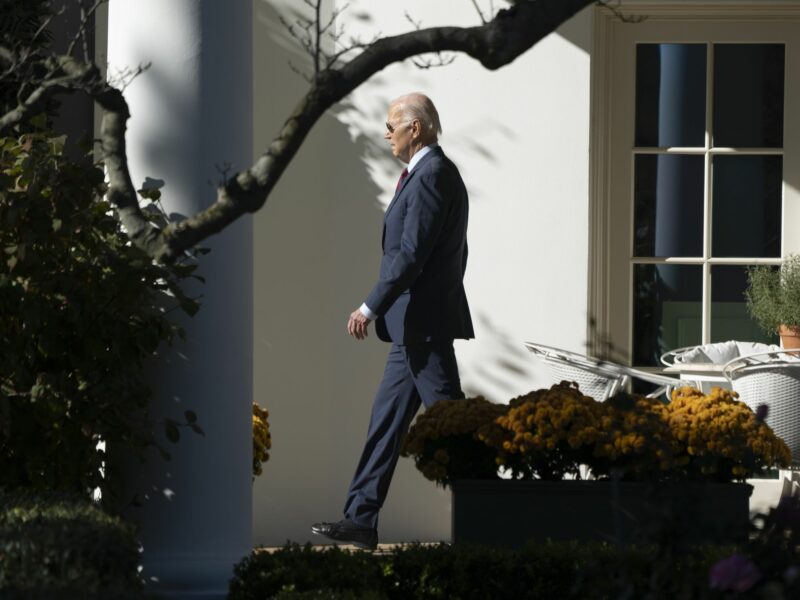 Photo of ​U.S. President Joe Biden walking toward the left of the image as he leaves the White House on Nov. 14