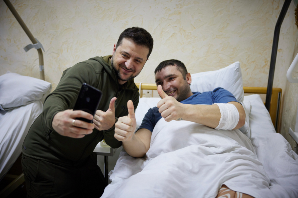 Photo of ​Zelenskyy posing for a selfie with a wounded Ukrainian soldier at a military hospital in Kyiv on March 13.