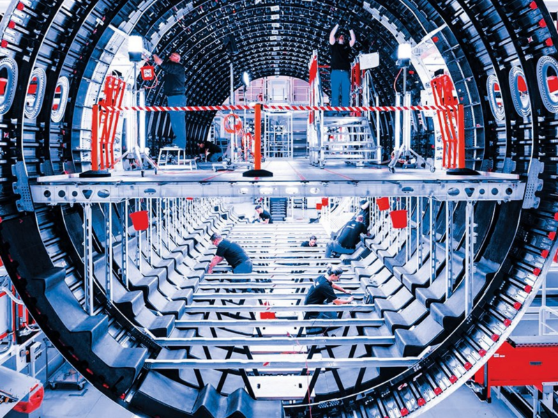 Photo of factory workers assembling an Airbus plane