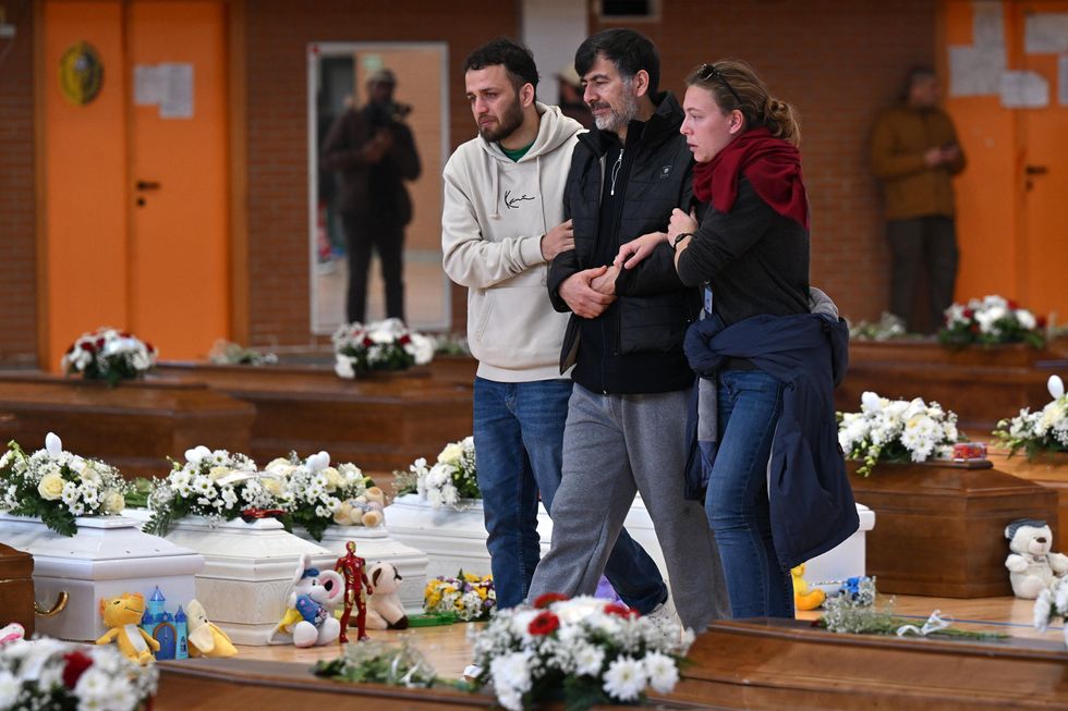 Photo of Families of the migrants that lost their lives after their boat sank off Italy's southern Calabria region visit their coffins in Steccato di Cutro.