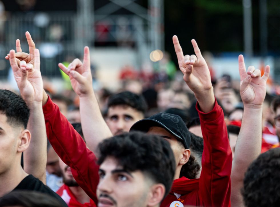 Photo of fans of the Turkish national team perform the ''wolf salute'', attributed to a far-right nationalist movement, during the public viewing of a match of the UEFA Euro 2024 Football Championship.