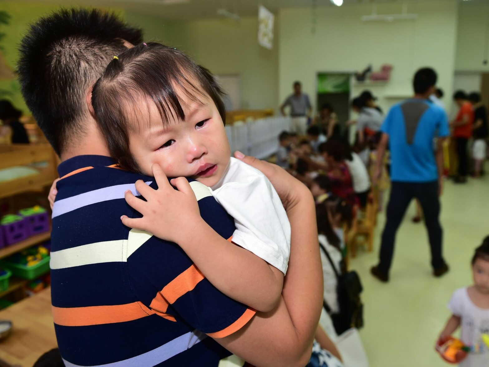 photo of father holding crying child