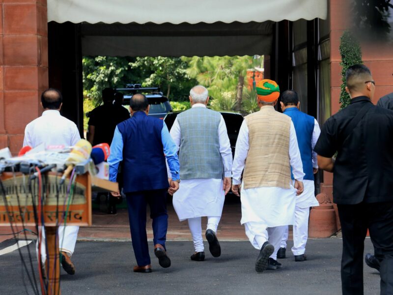 photo of five men walking away