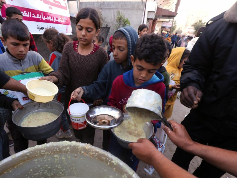 Photo of food being distributed to Palestinians as they break their fast, on the third day of Ramadan, in central Gaza.