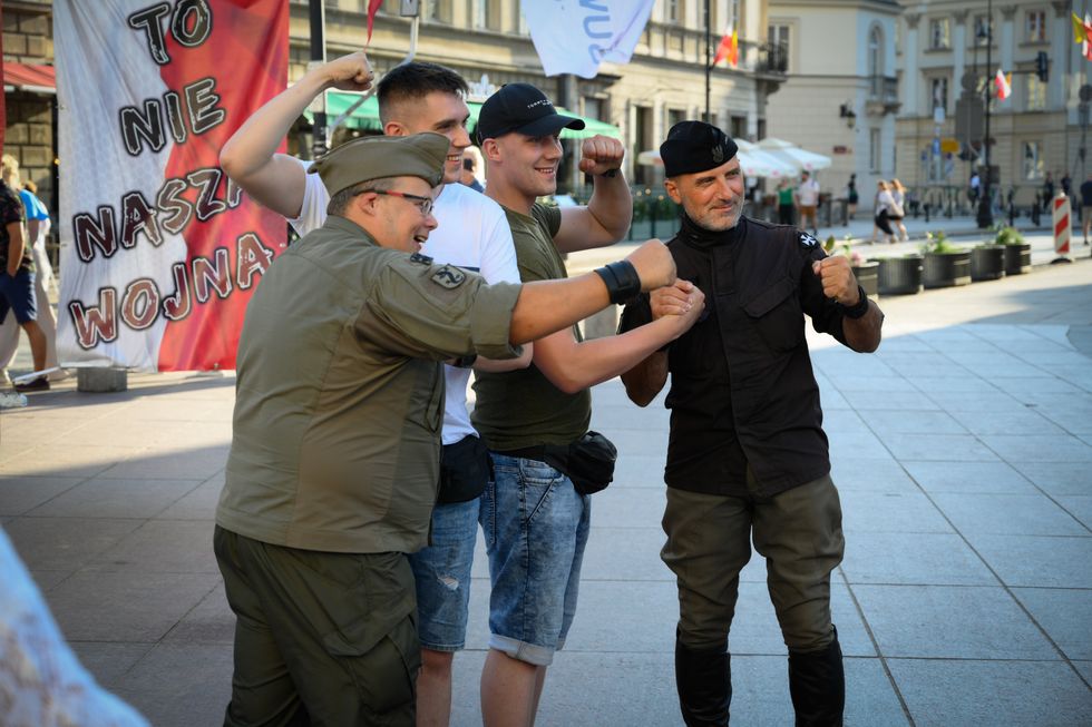 Photo of Former actor and far-right activist Wojciech Olszanski posing with fans in the city's Old Town during a damonstration against the war in Ukraine.