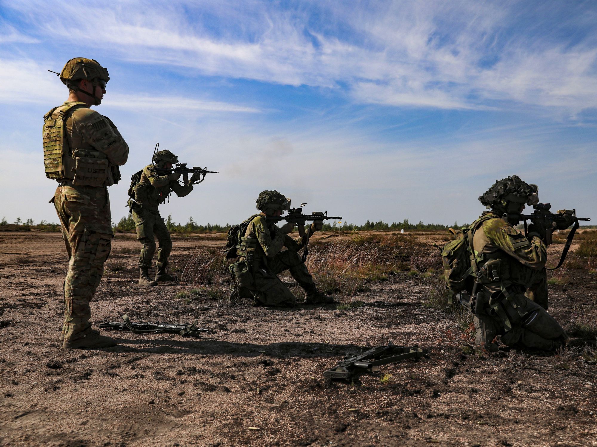 Photo of four members of the Finnish forces during an exercise in Niinisalo, Finland