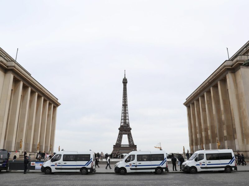 photo of French Police in front of the Eiffel Tower