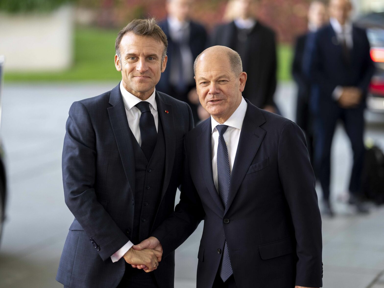Photo of French President Emmanuel Macron shaking hands with German Chancellor Olaf Scholz in Berlin on Oct. 18.