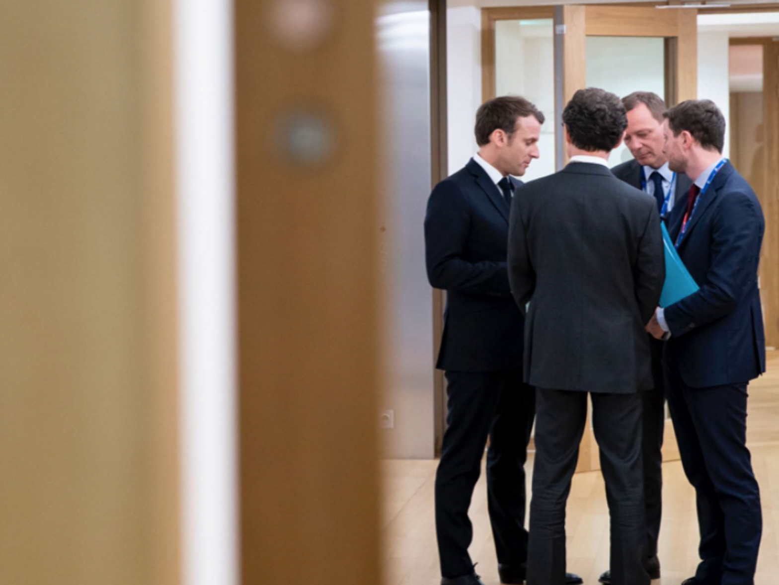 Photo of French President Emmanuel Macron speaking with a group of people in Brussels