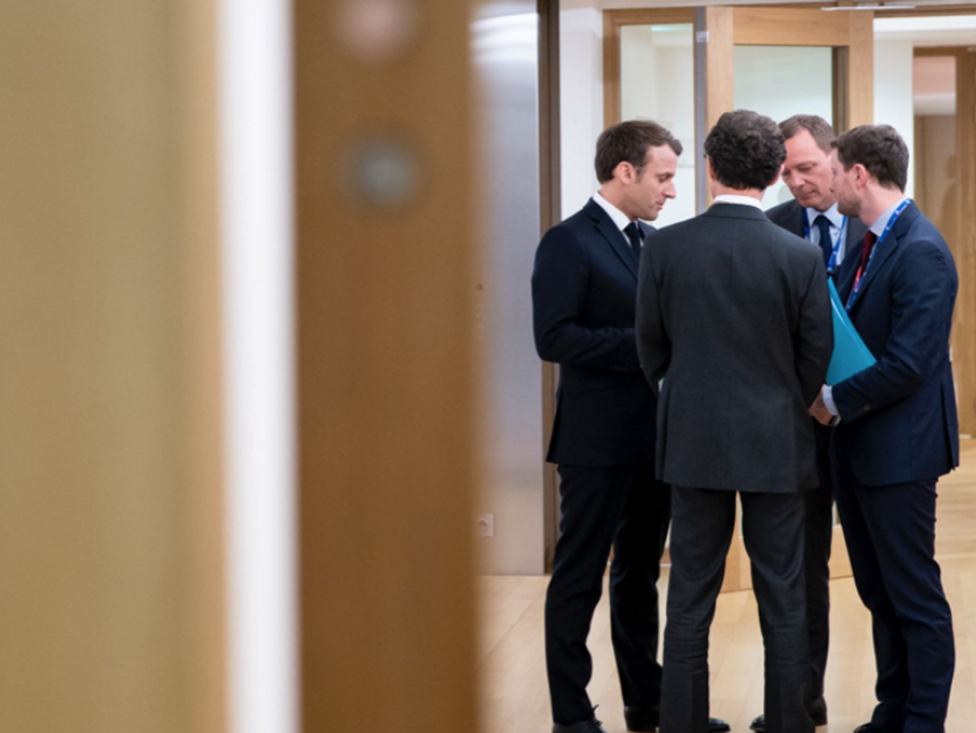 Photo of French President Emmanuel Macron speaking with a group of people in Brussels