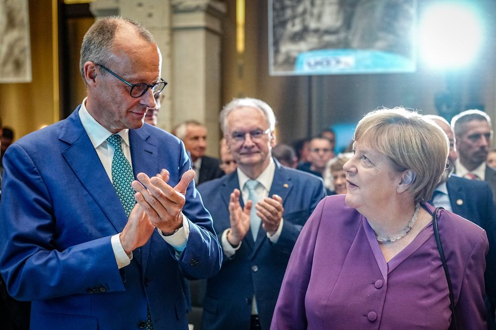 Photo of Friedrich Merz applauding former German Chancellor Angela Merkel at an event in Berlin on Sept. 24, 2024