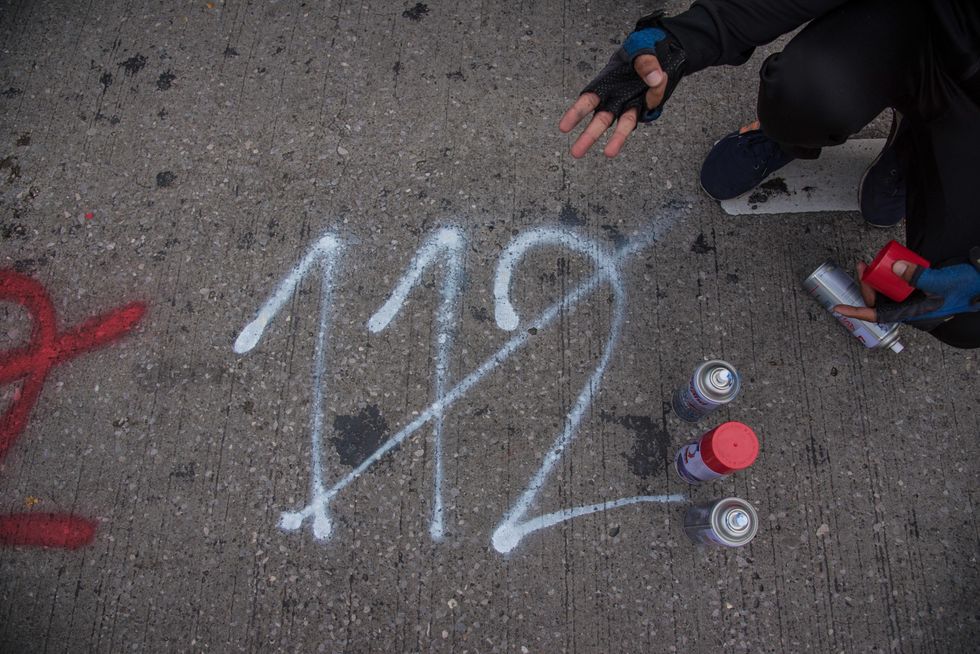 photo of graffiti of 112 crossed out on sidewalk