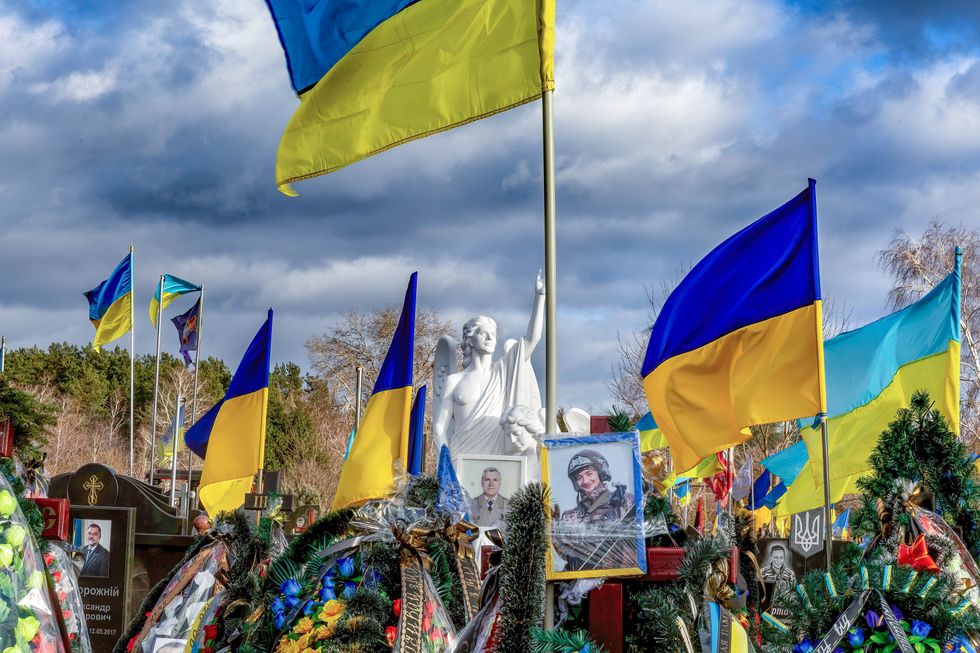 photo of Graves of fallen Ukrainian soldiers in Kyiv surrounded by flags