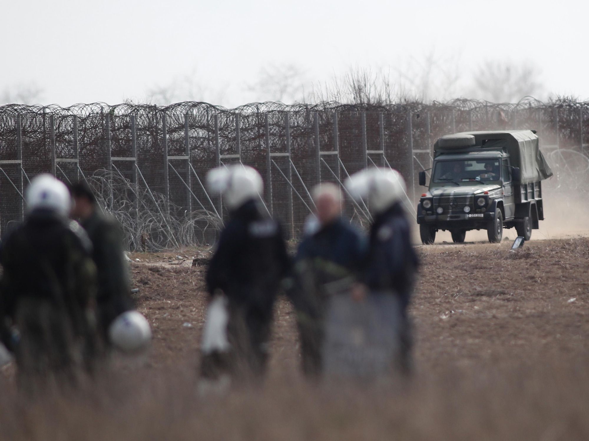 photo of Greek riot police patrol near Evros river, on the border with Turke
