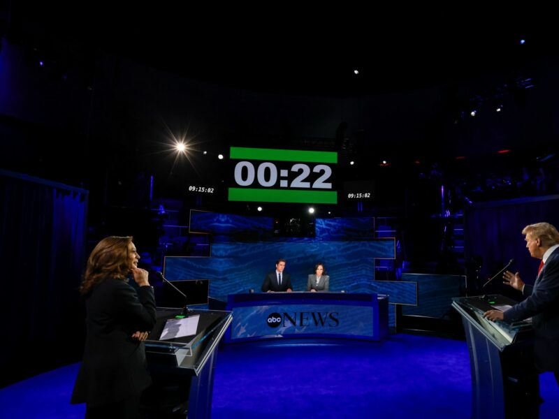 photo of harris and trump debating with stopwatch