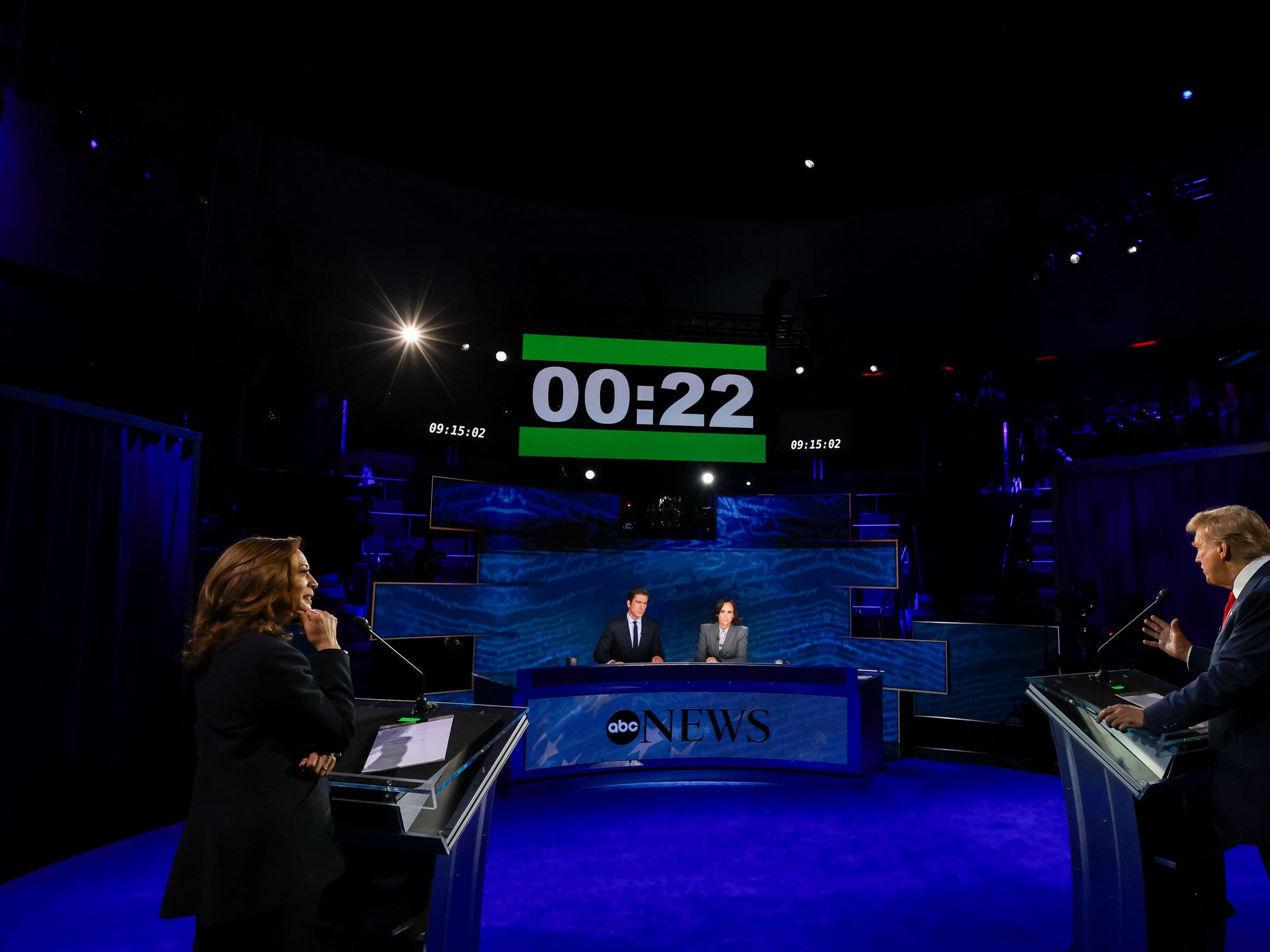 photo of harris and trump debating with stopwatch