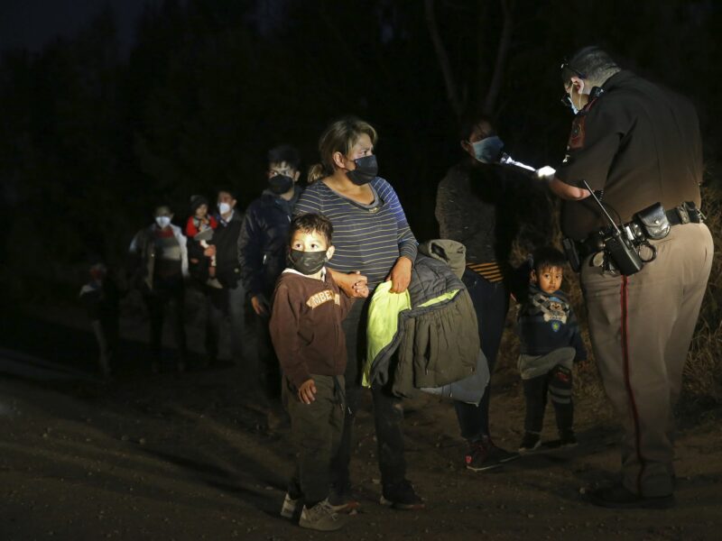 Photo of Hidalgo County Precinct 3 Constable Deputies gather information from migrants who crossed the Rio Grande in an area known as El Rincon del Diablo, the Devil's Corner.