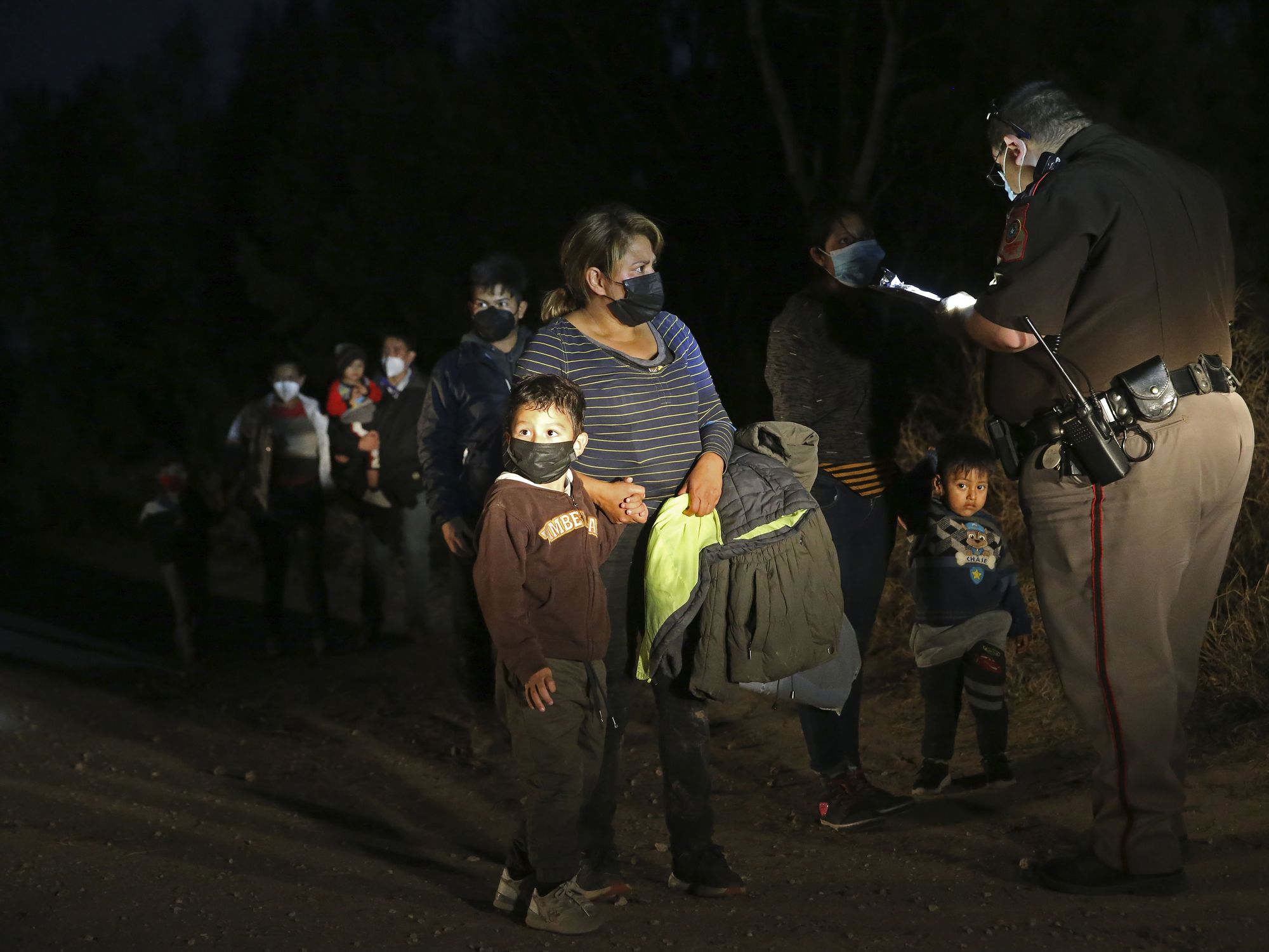 Photo of Hidalgo County Precinct 3 Constable Deputies gather information from migrants who crossed the Rio Grande in an area known as El Rincon del Diablo, the Devil's Corner.