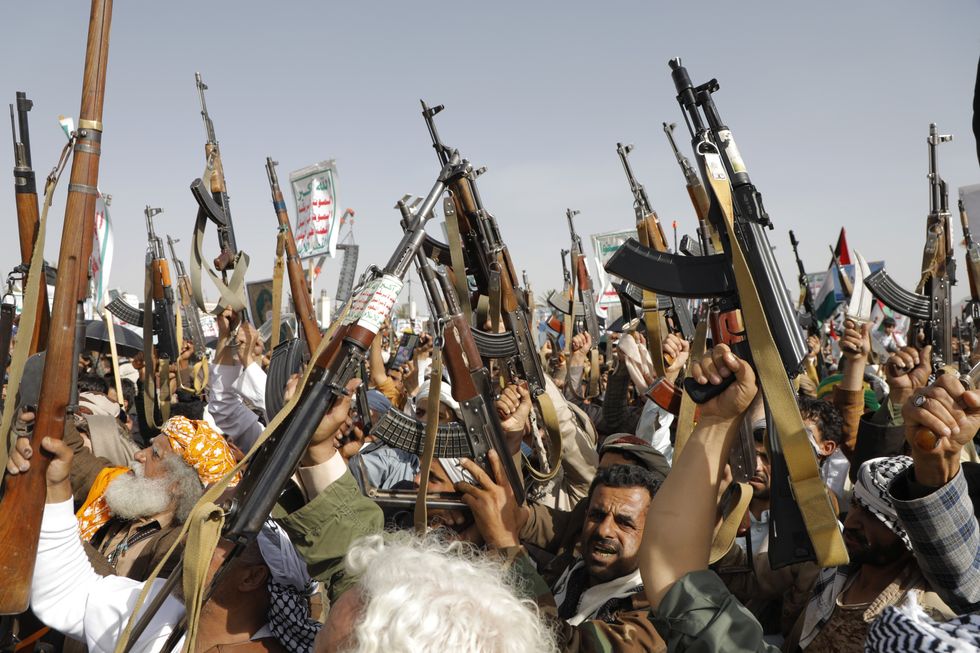 Photo of Houthi supporters holding up weapons during a protest against the U.S. and Israel in solidarity with the Palestinian people