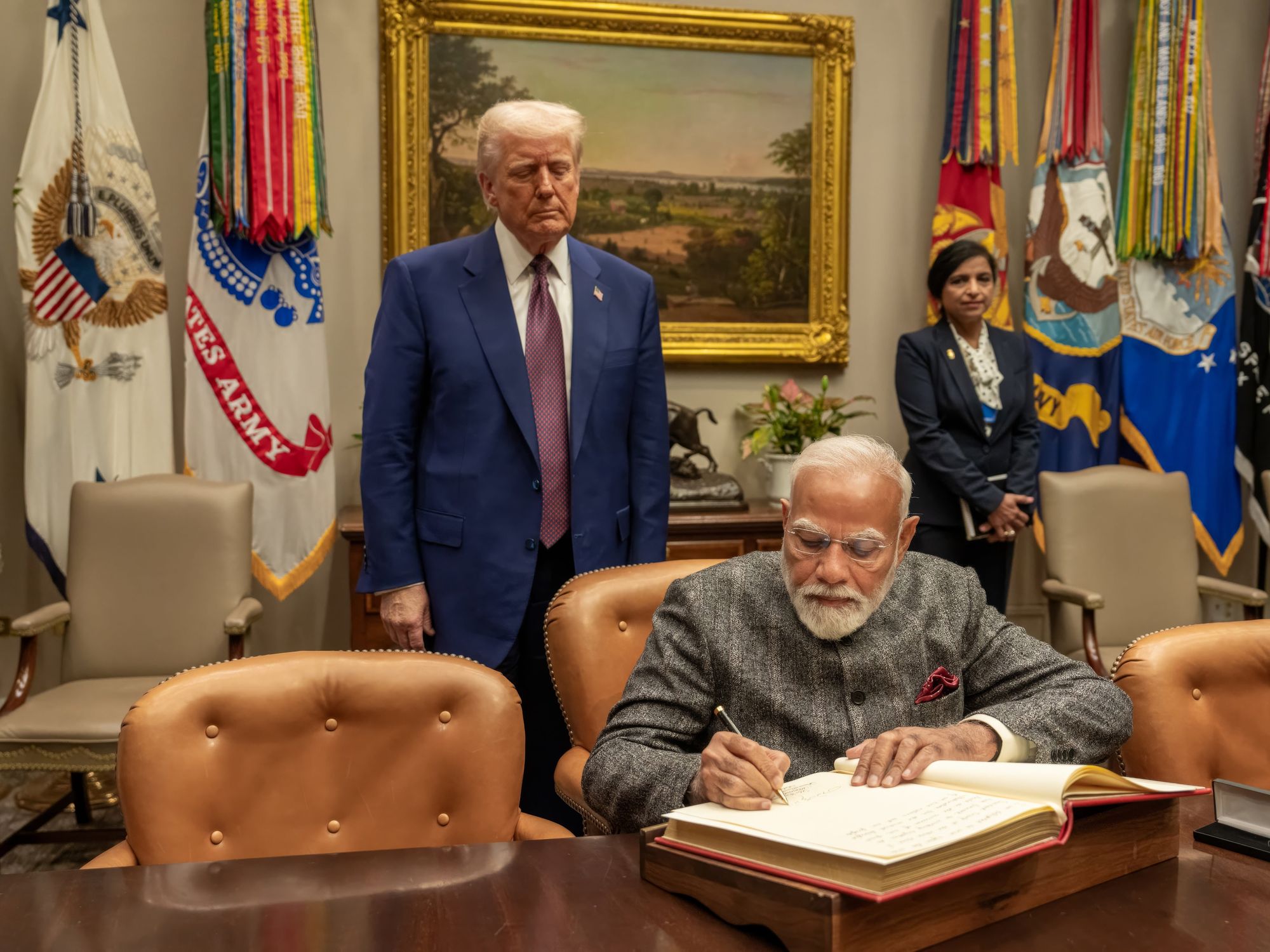 photo of Indian Prime Minister Narendra Modi signs the guest book at the White House on Thursday.