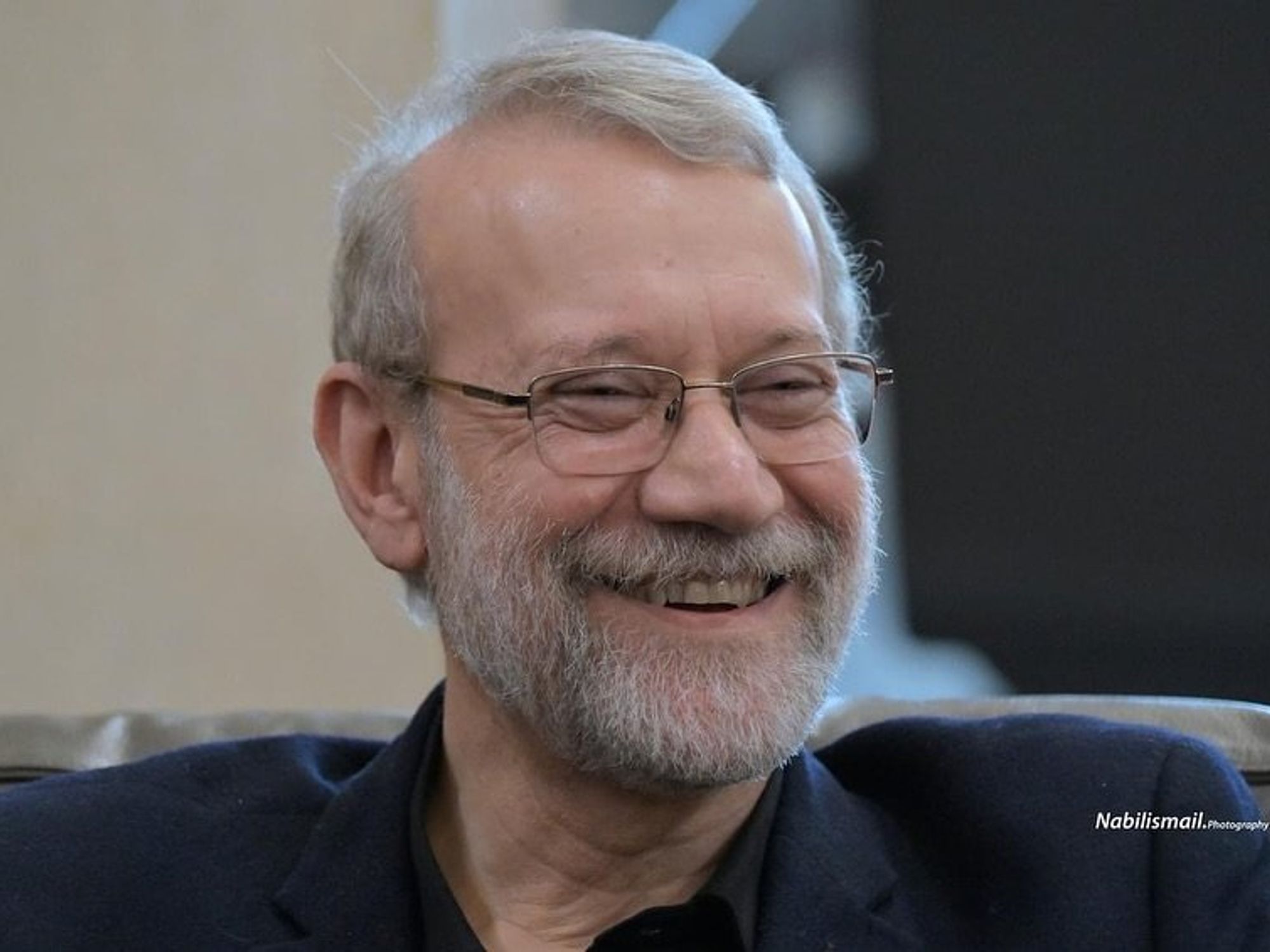 Photo of Iranian consultant, Ali Larijani, laughing in the aftermath of airstrikes in Beirut, Lebanon