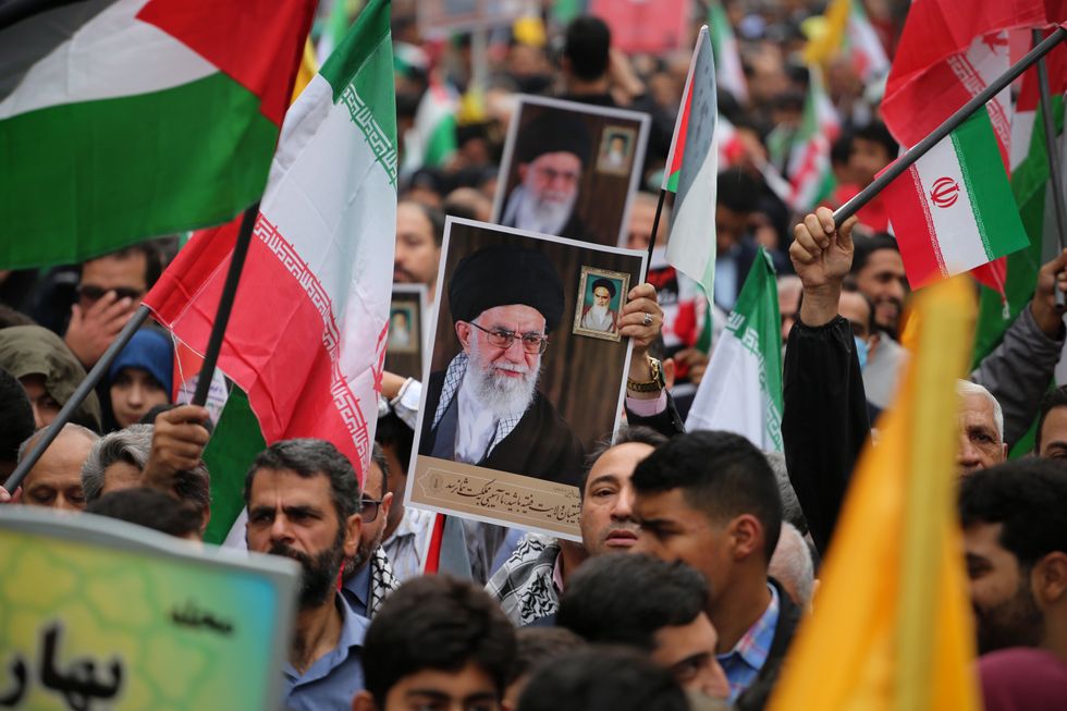 Photo of Iranian demonstrators holding a portrait of Iranian Supreme Leader Ayatollah Ali Khamenei.