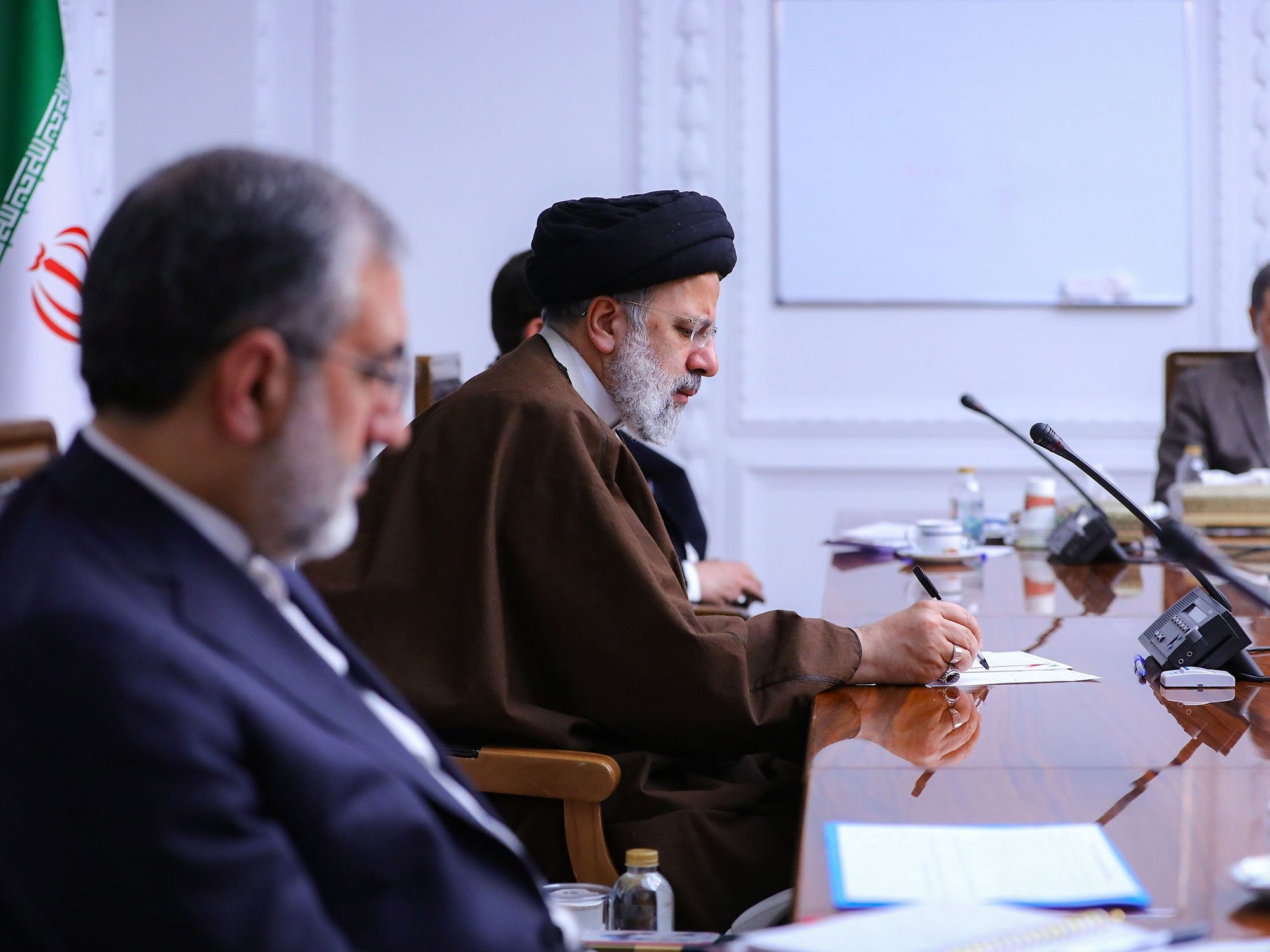 photo of Iranian President Ebrahim Raisi speaking into a microphone