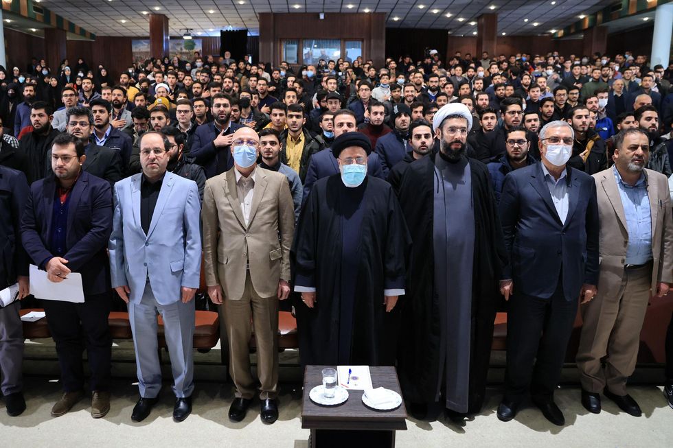 Photo of Iran's President EBRAHIM RAISI at Tehran University surrounded by other officials