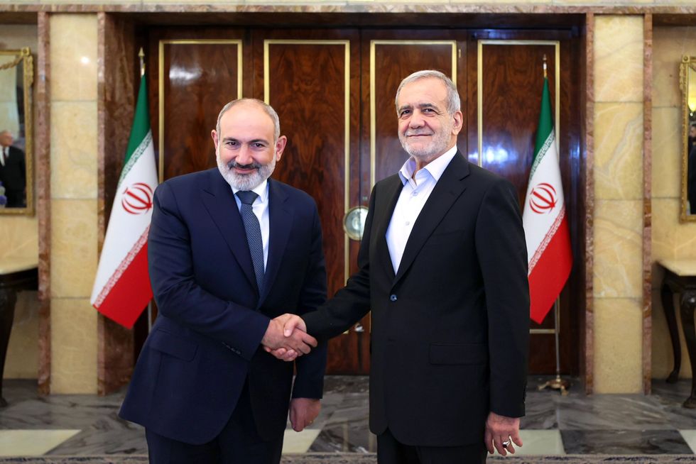 Photo of Iran's President Masoud Pezeshkian shaking hands with Armenia's Prime Minister Nikol Pashinyan in Tehran on July 30.