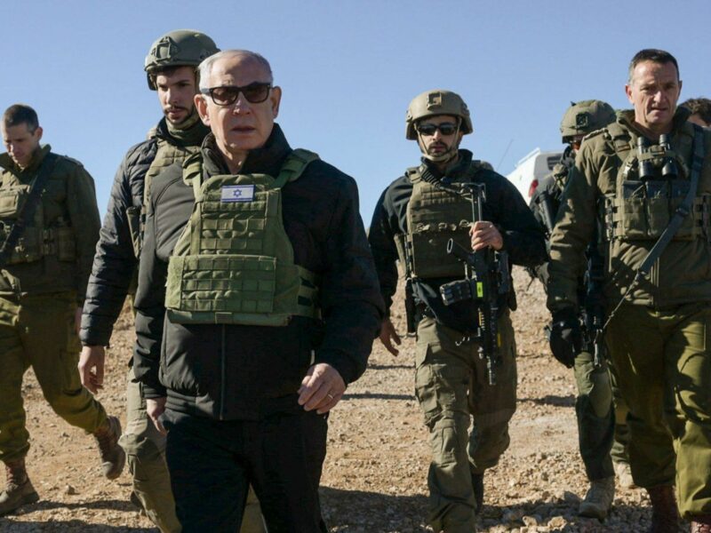 Photo of Israeli Prime Minister Benjamin Netanyahu in military gear walking alongside IDF troops on Dec. 17.
