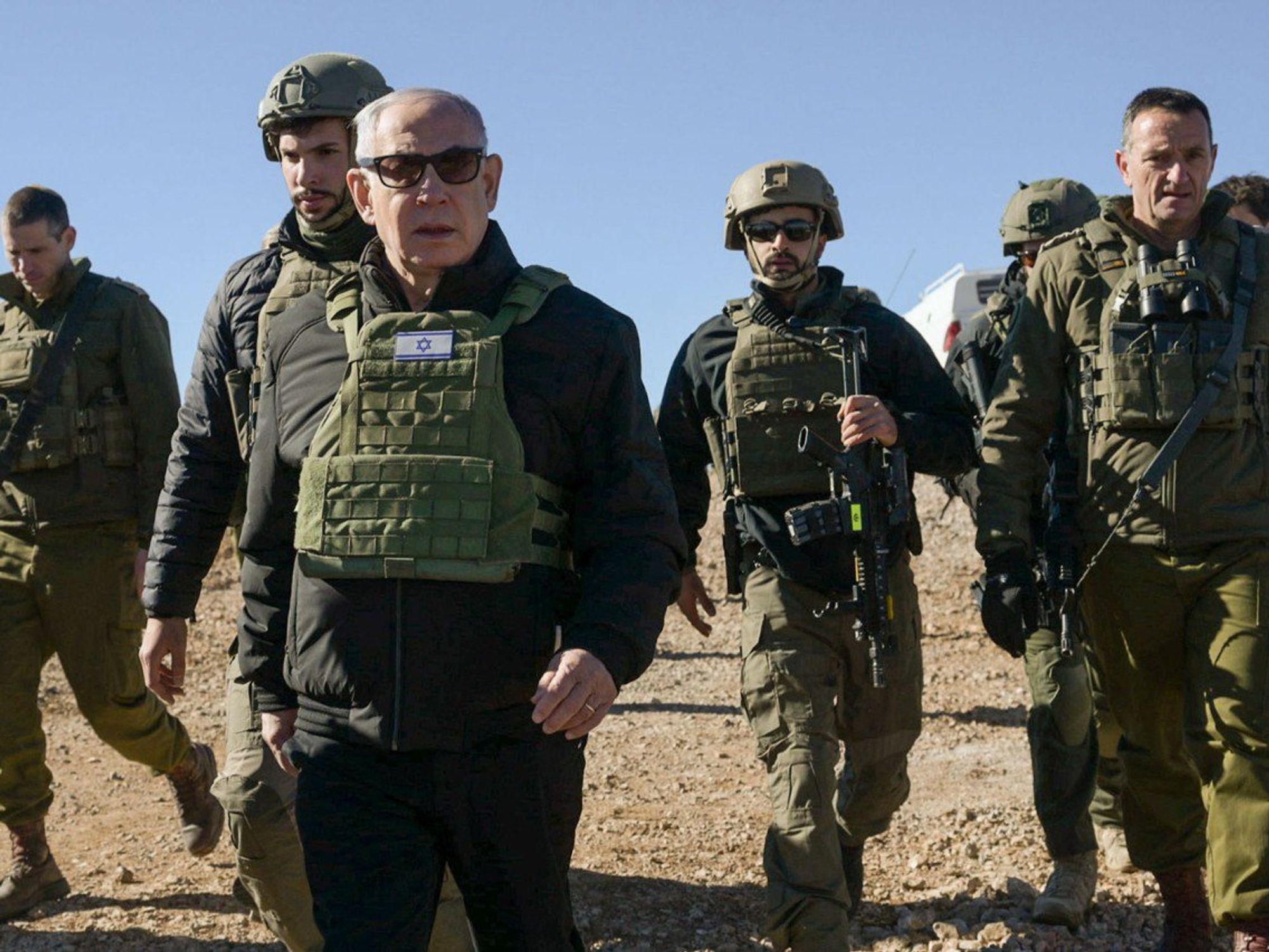 Photo of Israeli Prime Minister Benjamin Netanyahu in military gear walking alongside IDF troops on Dec. 17.