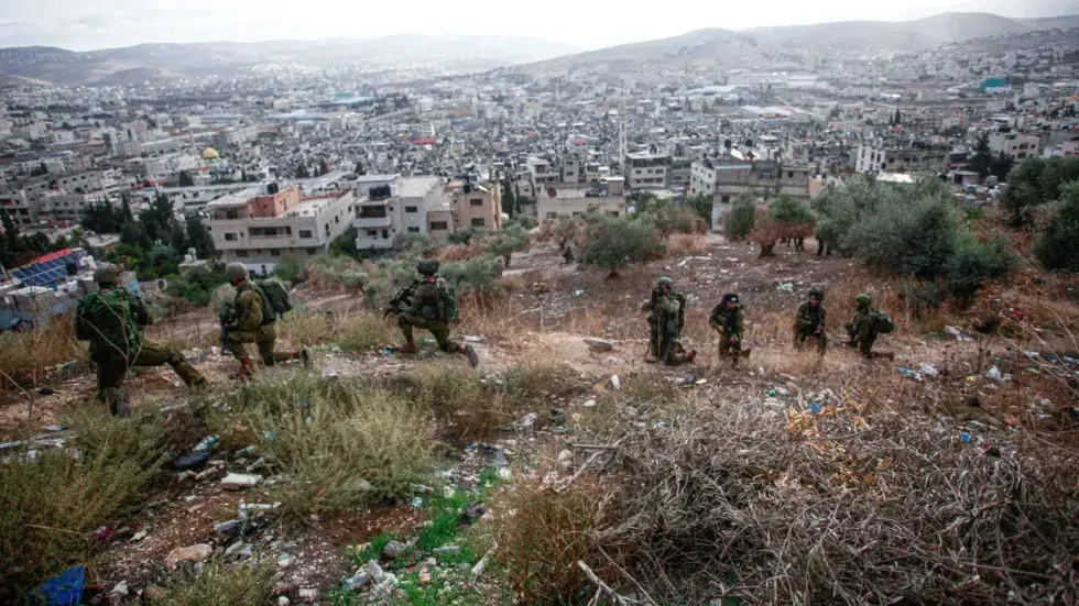 Photo of Israeli soldiers overlooking the Balata refugee camp, West Bank.