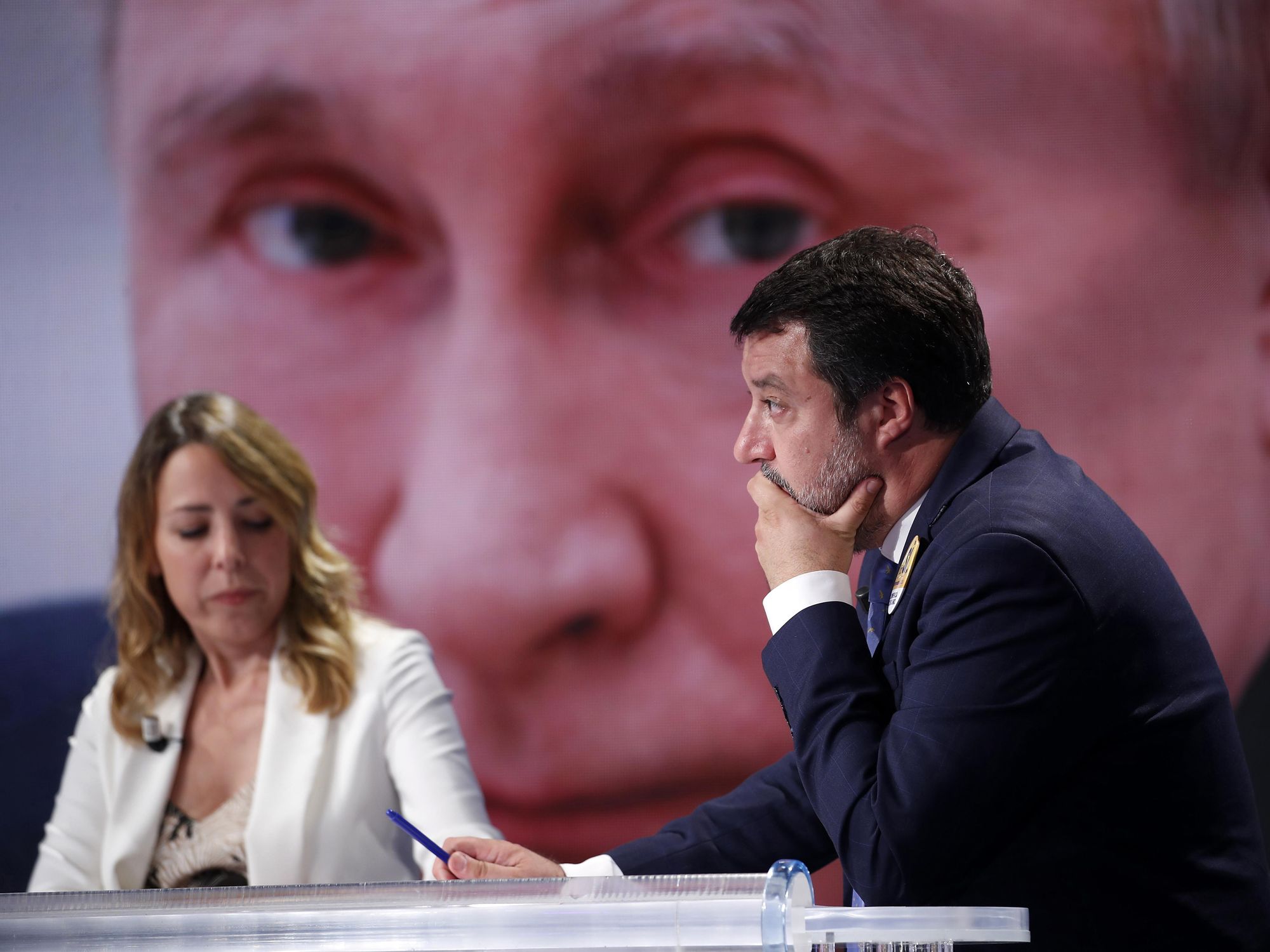 Photo of Italian far-right politician Matteo Salvini in front of a picture of Russian President Vladimir Putin