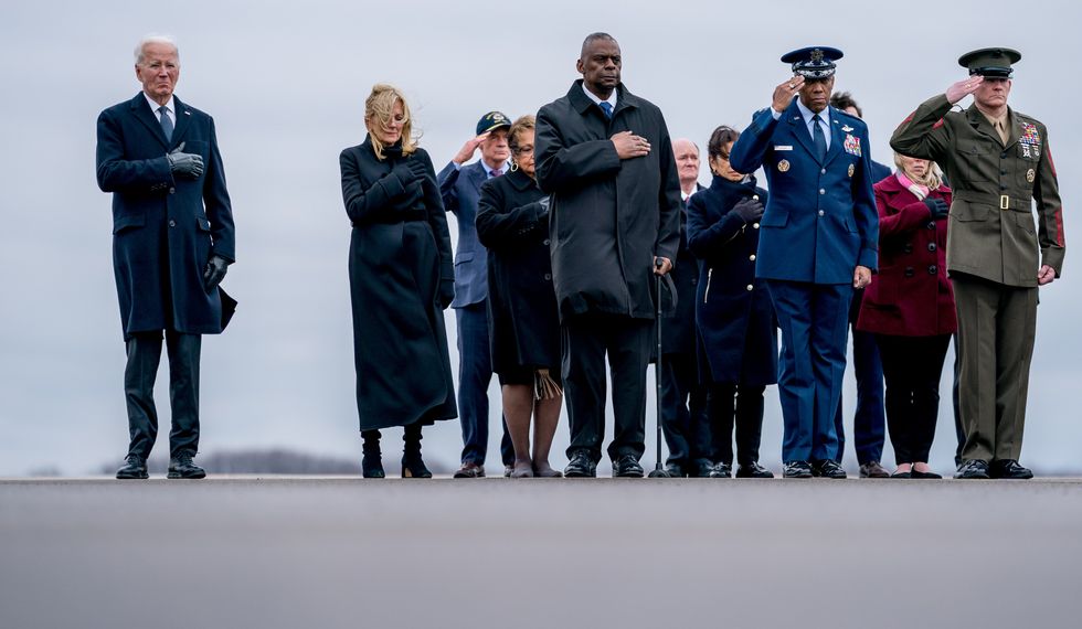 photo of joe biden and others lined up to honor killed soldiers