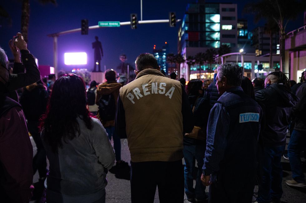 photo of journalist wearing Prensa vest