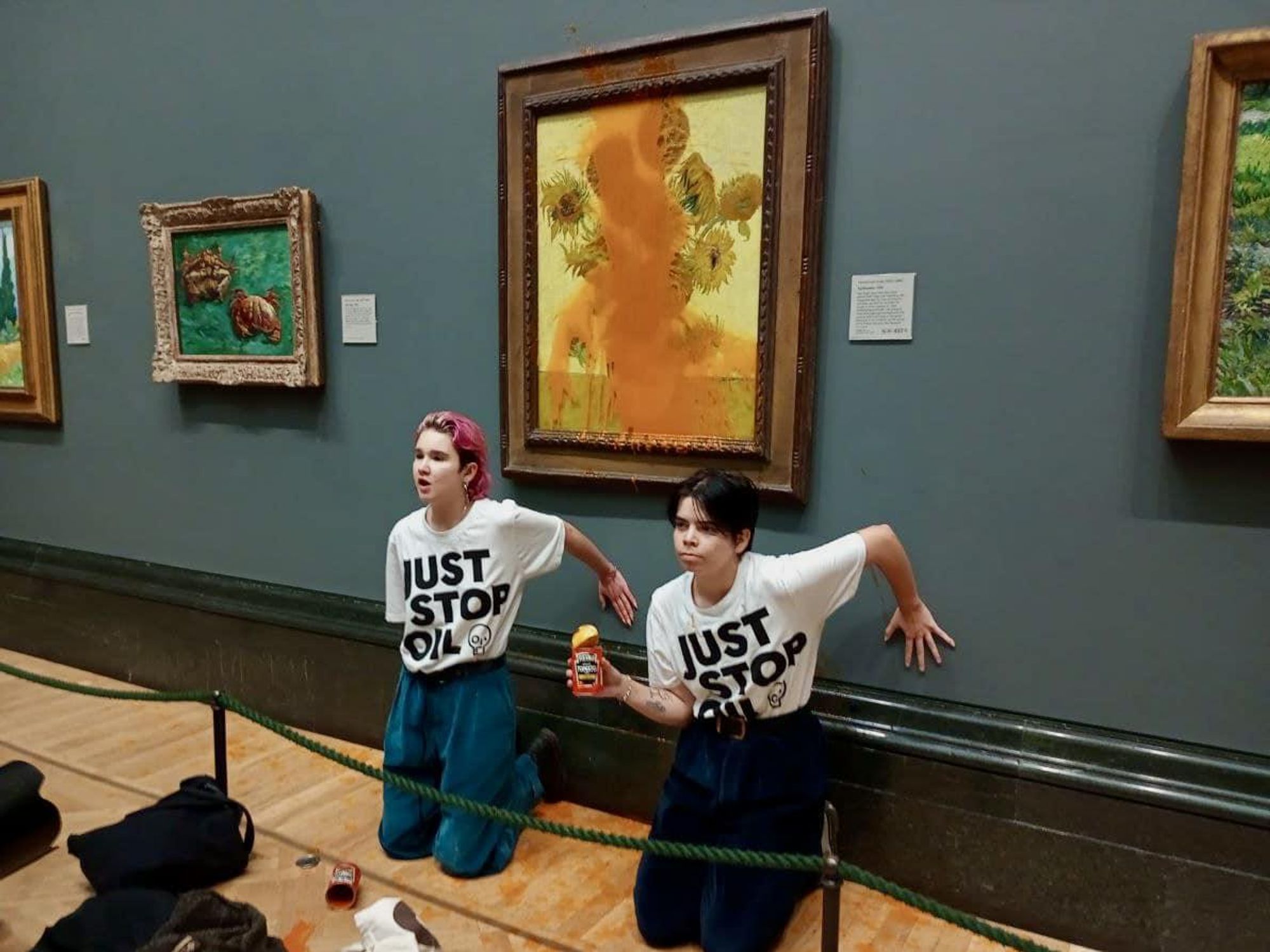 Photo of Just Stop Oil activists after splashing tomato soup across Van Gogh’s Sunflowers