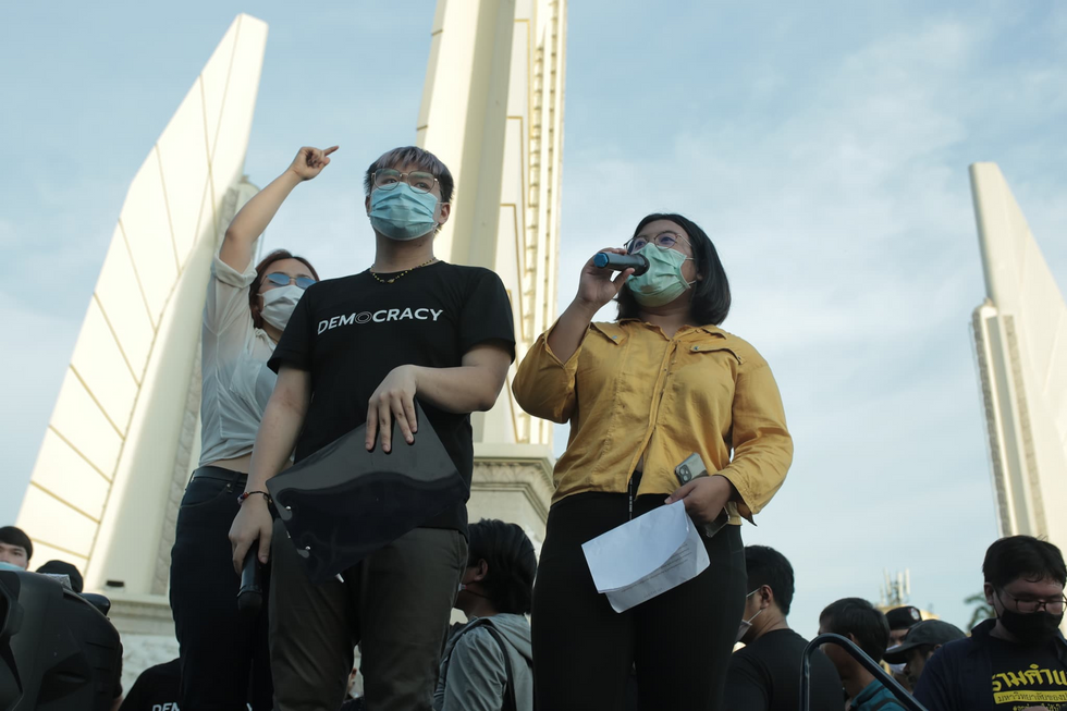Photo of Juthatip Sirikan speaks in front of democracy monument.