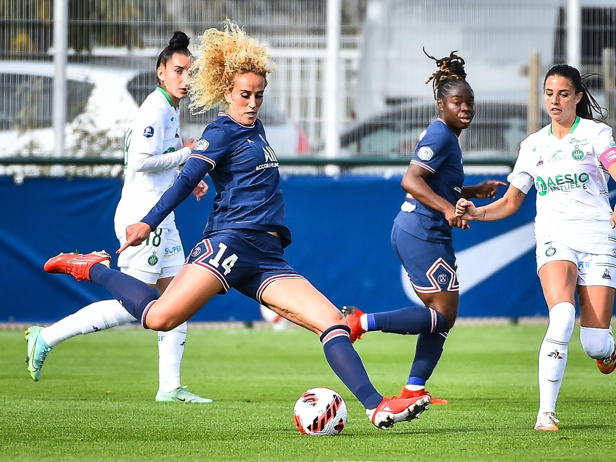photo of Kheira Hamraoui kicking a soccer ball